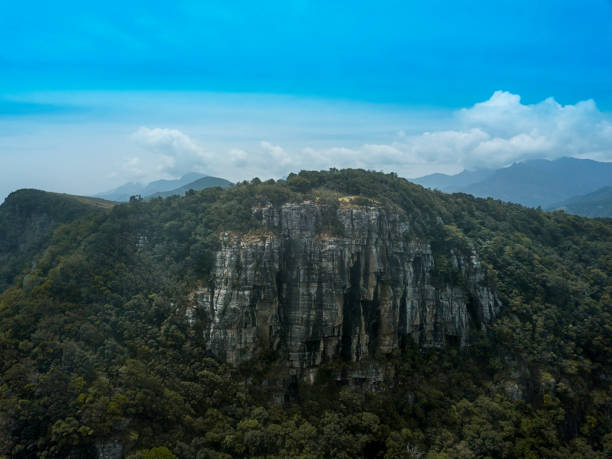 Front side drone view of Mini World's End, a rocky steep 90 degree cliff in the middle of a jungle at Pitawala Pathana, Riverston, Matale, Sri Lanka stock photo