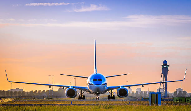 a front view of a airplane about to take off - schiphol stockfoto's en -beelden