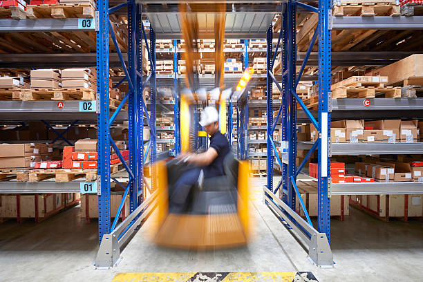 Front view of a man driving a forklift stock photo