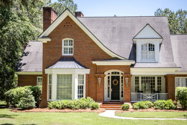 Front view of Exterior of Red Brick Traditional Southern Home Front view of Exterior of Red Brick Traditional Southern Home brick house stock pictures, royalty-free photos & images