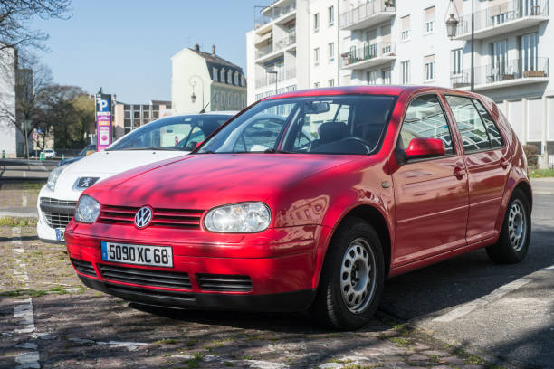 front view of red volkswagen golf mk4 parked in the street - golf imagens e fotografias de stock