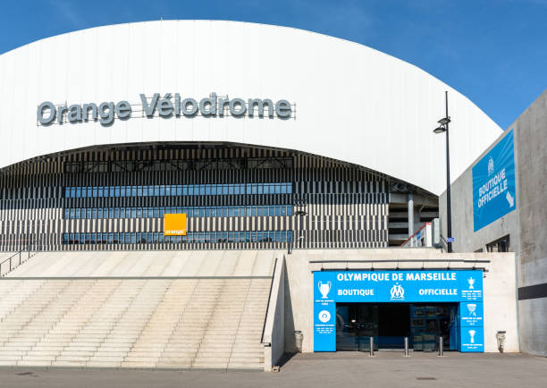 Front view of the main access to the Orange Velodrome stadium in Marseille, France, with the large stairway and the entrance of the official store of the club in the foreground. Marseille, France - May 18, 2018: The Orange Velodrome stadium is the emblematic stadium of the Olympique de Marseille football club and the second in France in terms of capacity with 67 394 places. Olympique de Marseille stock pictures, royalty-free photos & images