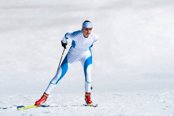 Front View of Young Adult Woman at Cross Country Skiing - Skate Technique stock photo