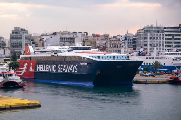 Front view on majestic HELLENIC SEAWAYS catamaran docking in front of city stock photo