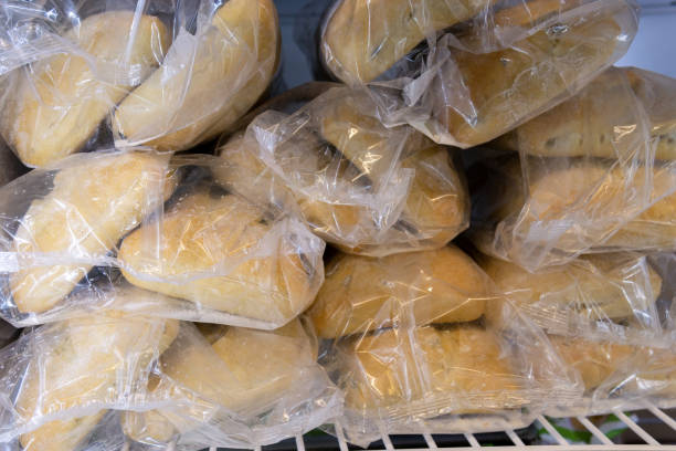 frozen bread in the supermarket refrigerator. Sale of ciabatta, loaf, hamburger buns stock photo