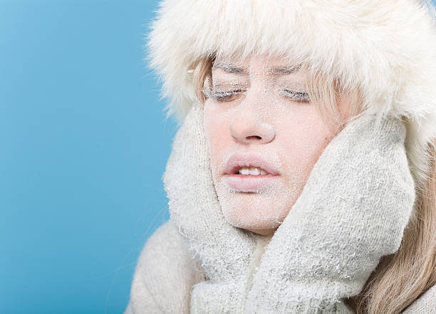 Frozen. Chilled female face covered in snow ice stock photo