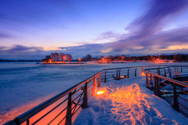 frozen lake during sunrise in winter season stock photo