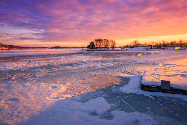 frozen lake during sunrise in winter season stock photo