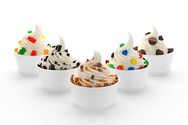 Frozen Yogurt Assortment "An assortment of frozen yogurt (or soft serve ice cream), with various toppings, in  standard disposable restaurant portion cups." dessert topping stock pictures, royalty-free photos & images