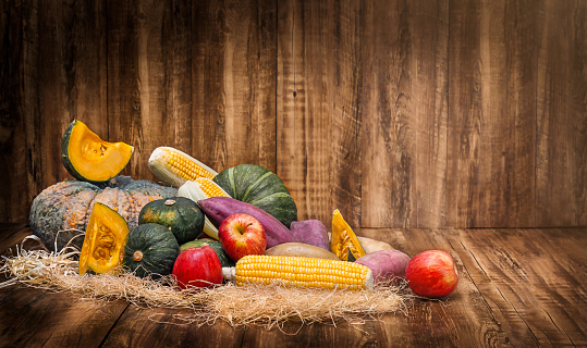 Fruit and vegetable harvest ingredients for thanksgiving day on wooden background