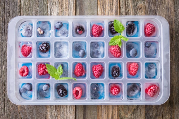 Fruit ice cubes with organic berries stock photo