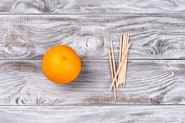 Fruit Orange and orange Wood Sticks Cuticle Pushers for Manicure. Copyspace for your text, banner stock photo