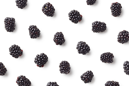 Fruit pattern of blackberries isolated on white background. Top view. Flat lay