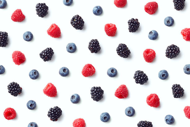 Fruit pattern of colorful wild berries Fruit pattern of colorful wild berries isolated on white background. Raspberries, blueberries and blackberries. Top view. Flat lay berry stock pictures, royalty-free photos & images
