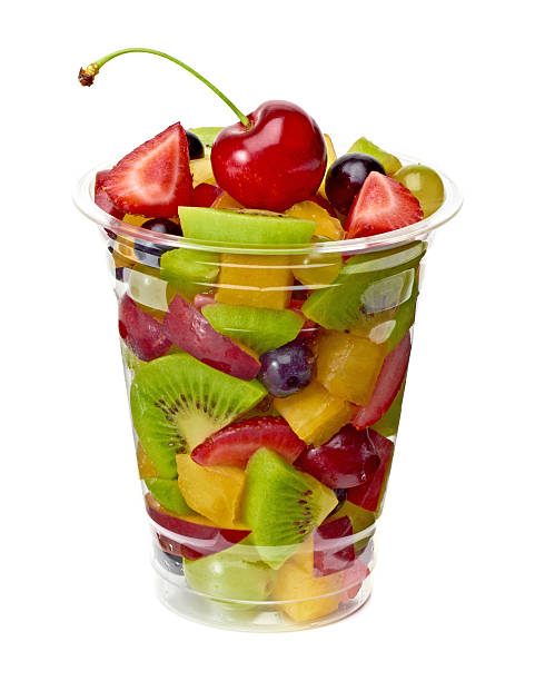 Fruit salad in plastic cup Fruit salad in plastic cup on white background fruit salad stock pictures, royalty-free photos & images