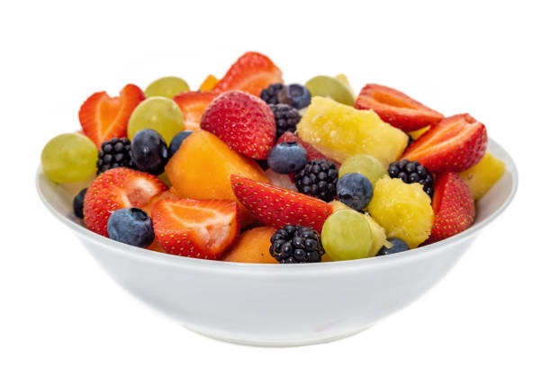 Fruit salad Fruit salad in a bowl - white background fruit salad stock pictures, royalty-free photos & images