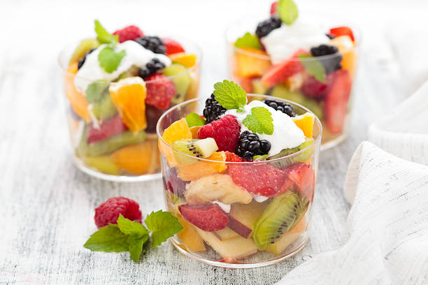 Fruit Salad. Fruit Salad in small elegant glasses. Shallow dof. fruit salad stock pictures, royalty-free photos & images