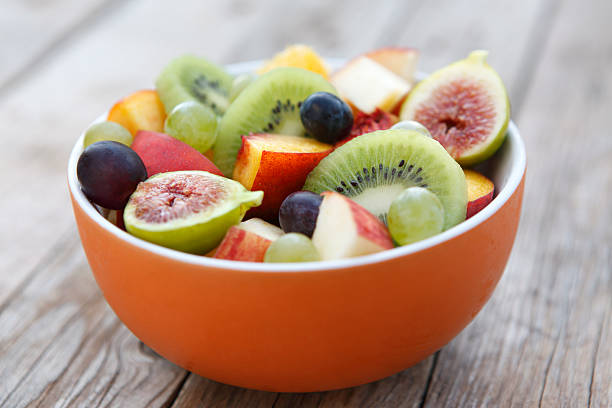 Fruit Salad "Mix of mango, kiwi, fig, apple, grape and peach." fruit salad stock pictures, royalty-free photos & images