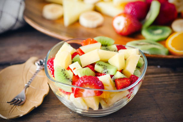 fruit salad salad with fresh fruits and berries fruit salad stock pictures, royalty-free photos & images