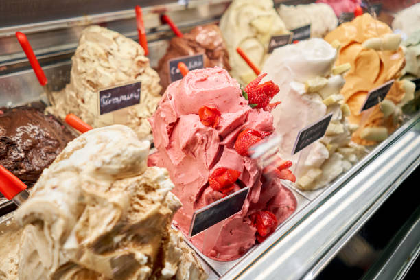 Fruit with strawberries Gelato. Flavors various ice cream in Rome, Italy. Italian gelateria. Assortment of colorful gelato on cafe showcase. Natural fresh ice cream. stock photo