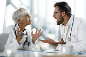 istock Frustrated doctors arguing on a meeting in hospital. 1365557714