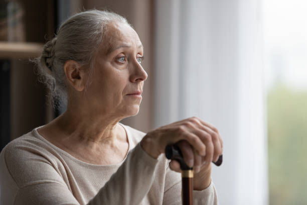 Frustrated middle aged woman with walking disability looking in distance. stock photo