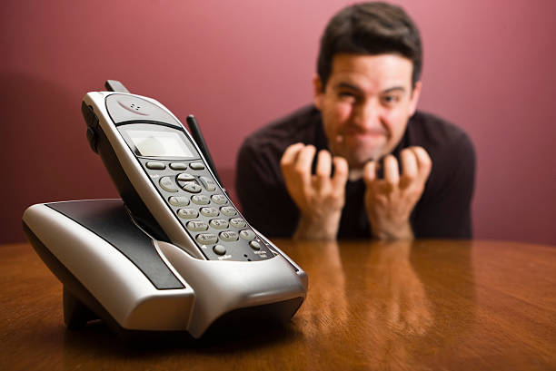 Frustrated waiting for the phone to ring stock photo