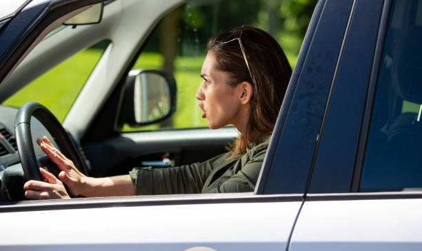 Frustrated woman driving car stock photo