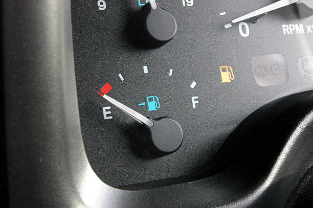 fuel guage, car dashboard (instrument cluster) "Fuel guage on empty, Fuel light on.I would recommend designers put a nice, simple orange outerglow on the fuel light if it needs to be highlited more." fuel bowser stock pictures, royalty-free photos & images