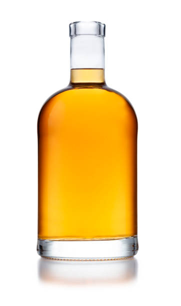A full bell shaped bottle of golden whisky, with no label or branding, isolated on white A full bell shaped bottle of golden whisky, with no label or branding, isolated on white with a slight reflection brandy stock pictures, royalty-free photos & images