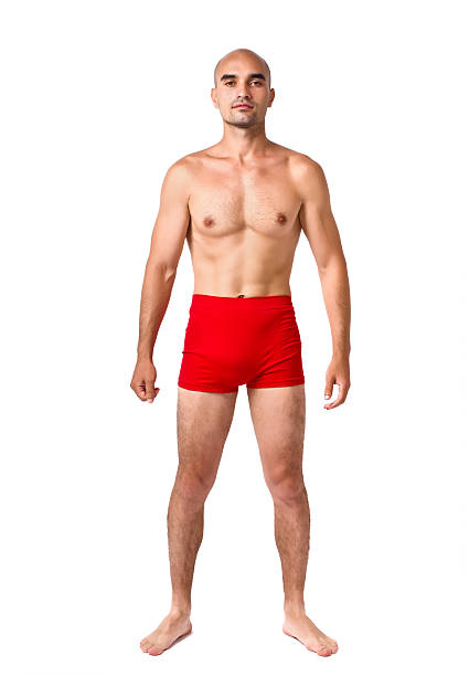 Full body of fit muscular man wearing only red underwear. stock photo