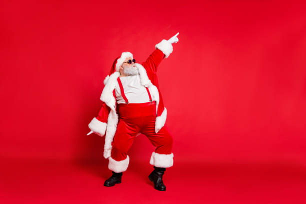 Full body photo of overweight carefree delightful ecstatic active energetic listening hip-hop music chic grandfather pointing finger up enjoying rhythm movement has big belly isolated vivid background Full body photo of overweight carefree delightful ecstatic active energetic, listening hip-hop music chic grandfather pointing finger up enjoying rhythm movement has big belly isolated vivid background christmas stock pictures, royalty-free photos & images