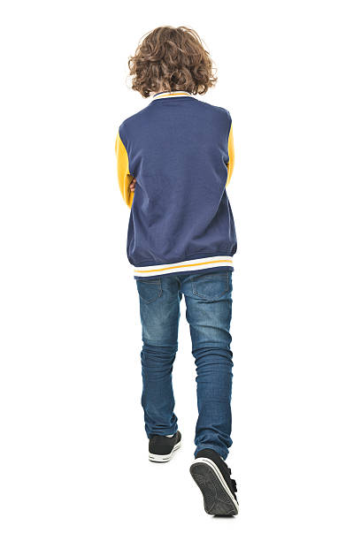 full body portrait of back of 8 years old boy stock photo