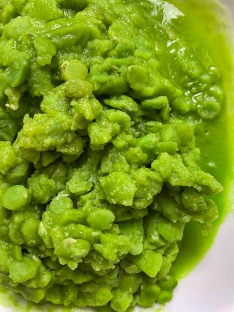 Full frame image of portion of green, mushy peas on a plate, elevated view stock photo