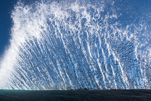 Full frame of water spraying into sky from crashing ocean wave