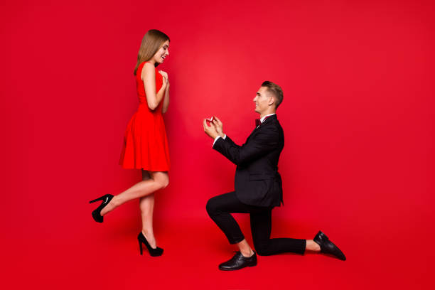 Full length body size of two attractive affectionate cheerful pe Full length body size of two attractive affectionate cheerful people delighted glad lady getting receiving engaging offer guy standing on one knee isolated over bright vivid shine red background fiancé stock pictures, royalty-free photos & images