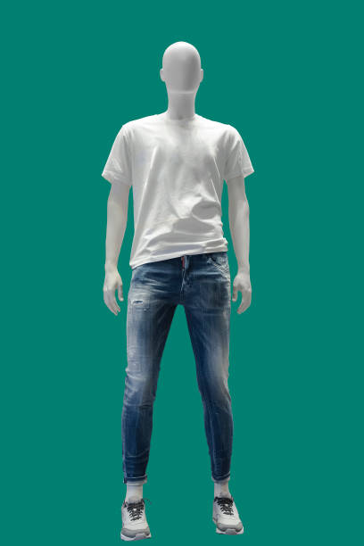 Full length male mannequin. Full length male mannequin dressed in t- shirt and blue ripped jeans, isolated on a green background. No brand names or copyright objects. mannequin stock pictures, royalty-free photos & images