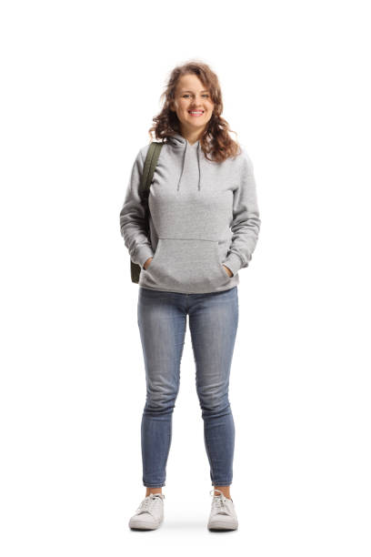 Full length portrait of a female student standing and smiling at the camera stock photo