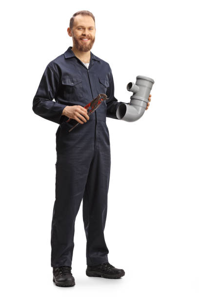 Full length portrait of a plumber holding a plastic pipe and pliers stock photo