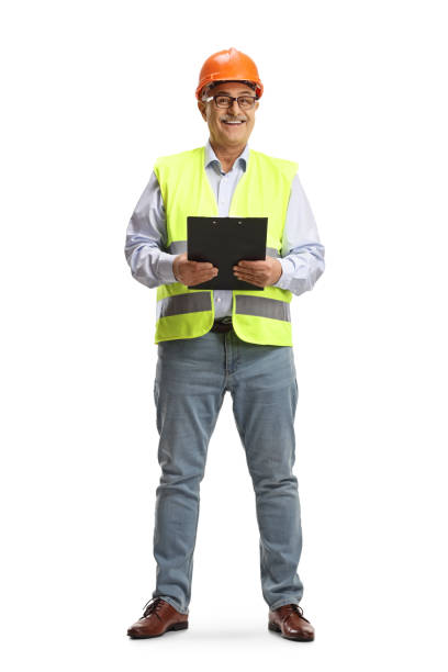 Full length portrait of a smiling mature male engineer holding a clipboard stock photo