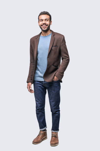 Full length portrait of handsome smiling young man looking up Cheerful young men looking up. Isolated on gray background clipping path stock pictures, royalty-free photos & images