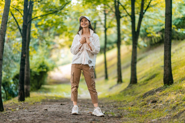 Full length portrait of young and beautiful woman in nature stock photo