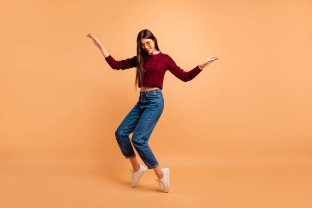 full length side profile body size photo beautiful she her lady ideal appearance look dancing star queen hands arms raised wear casual red burgundy knitted pullover isolated pastel beige background - dancing imagens e fotografias de stock