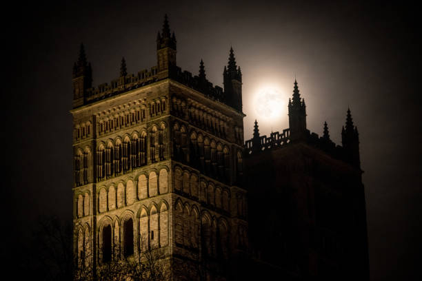 Full moon behind the West towers of Durham Cathedral April full moon passes behind the west towers of Durham Cathedral in England, UK Durham Cathedral stock pictures, royalty-free photos & images