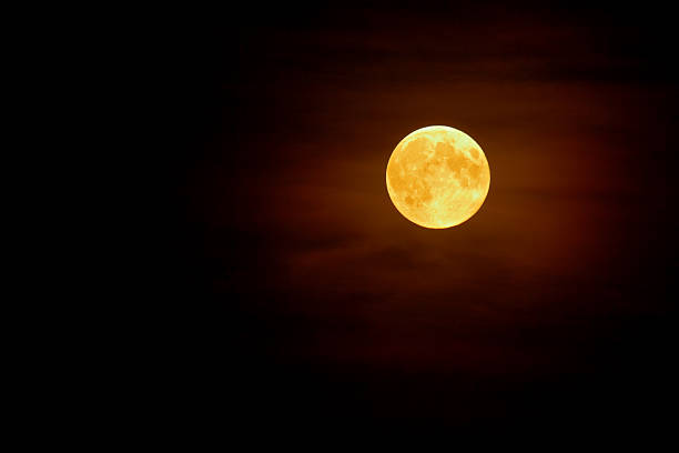 Full moon in the mist on dark night sky background stock photo