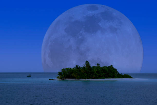 A full moon over the Maldives in the tropical waters of the Indian Ocean stock photo