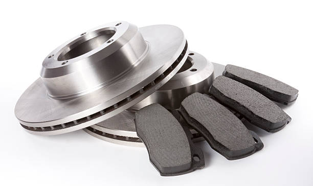 Full Set Brake Discs and Pads Studio shot of a full set of front brake discs and pads on a white background.View Full Category: brake stock pictures, royalty-free photos & images
