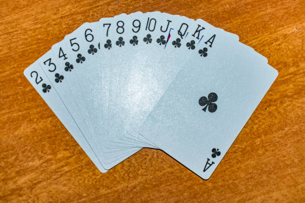 A full set of clubs in Playing card laying on the table with an different arrangement. stock photo