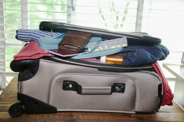 Full suitcase packed for vacation without more space stock photo