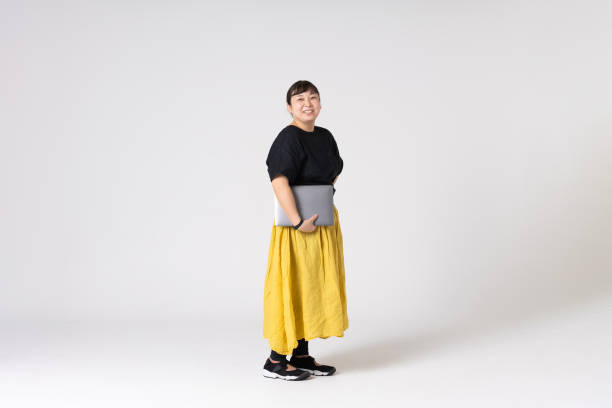 Full-length portrait of an Asian woman on a white background. stock photo